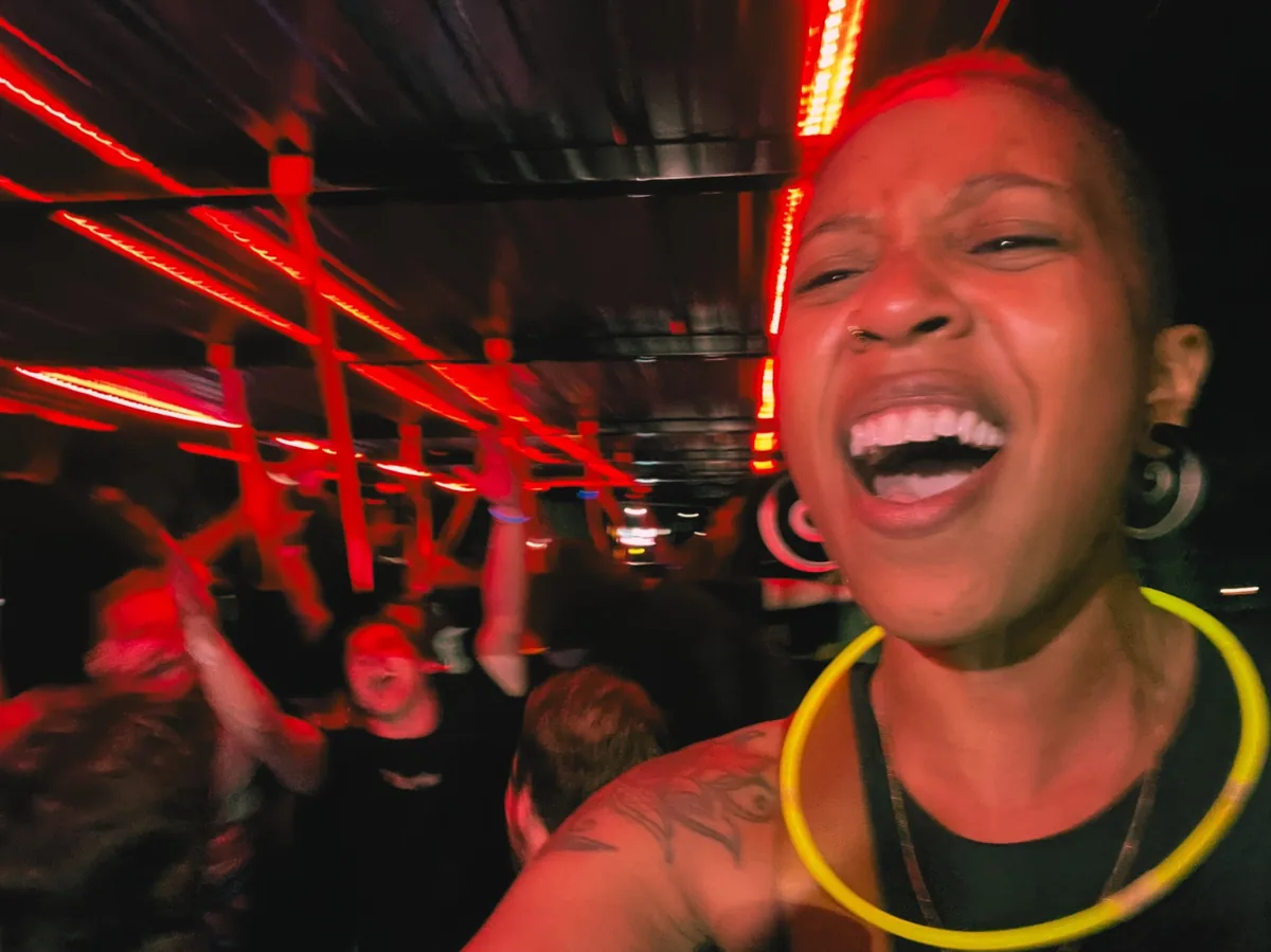 Excited woman laughing inside the SuFu Tractor party wagon with red LED lights in Sioux Falls