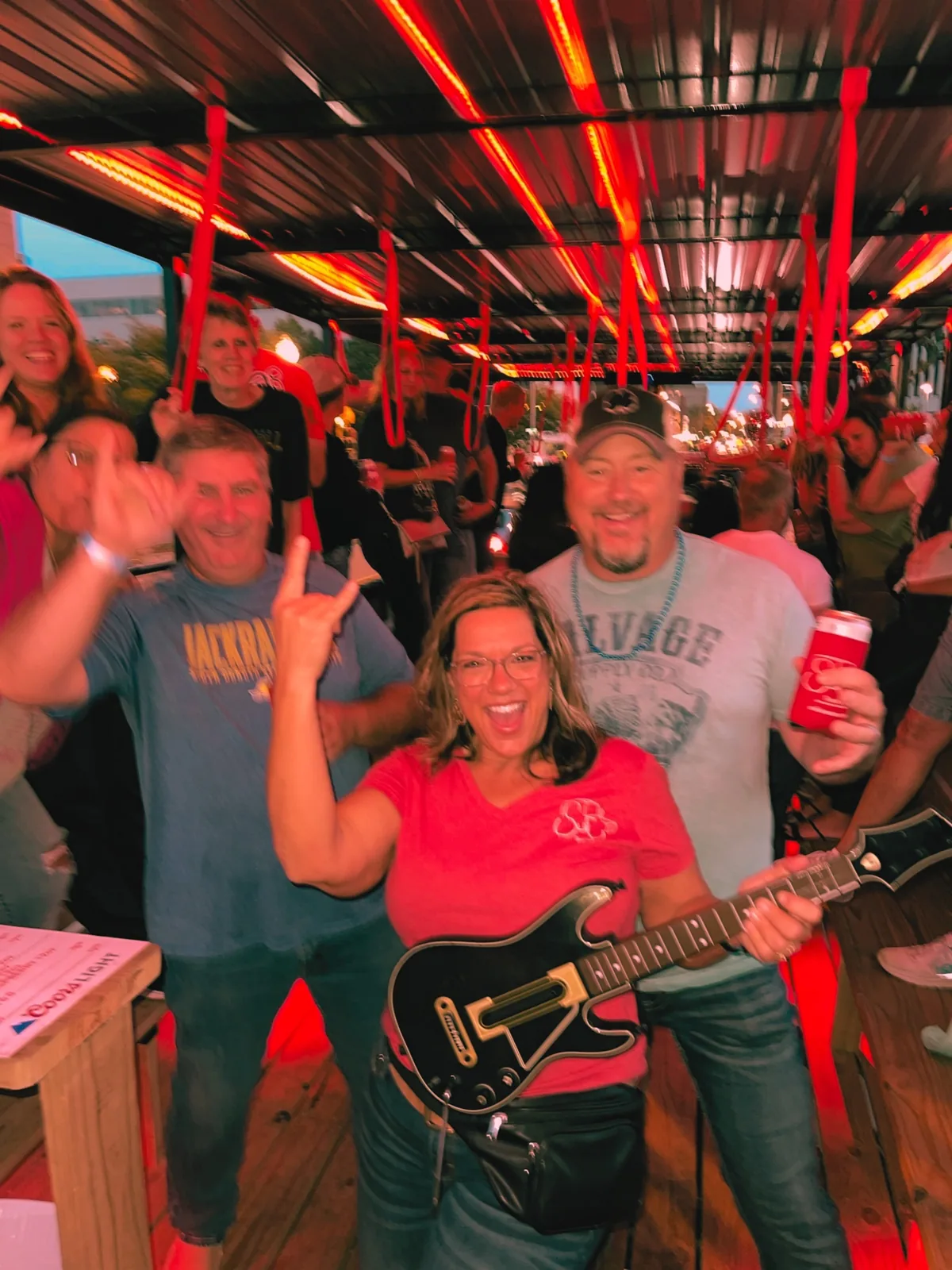 SuFu Tractor host playing guitar hero with party guests on the wagon in downtown Sioux Falls SD