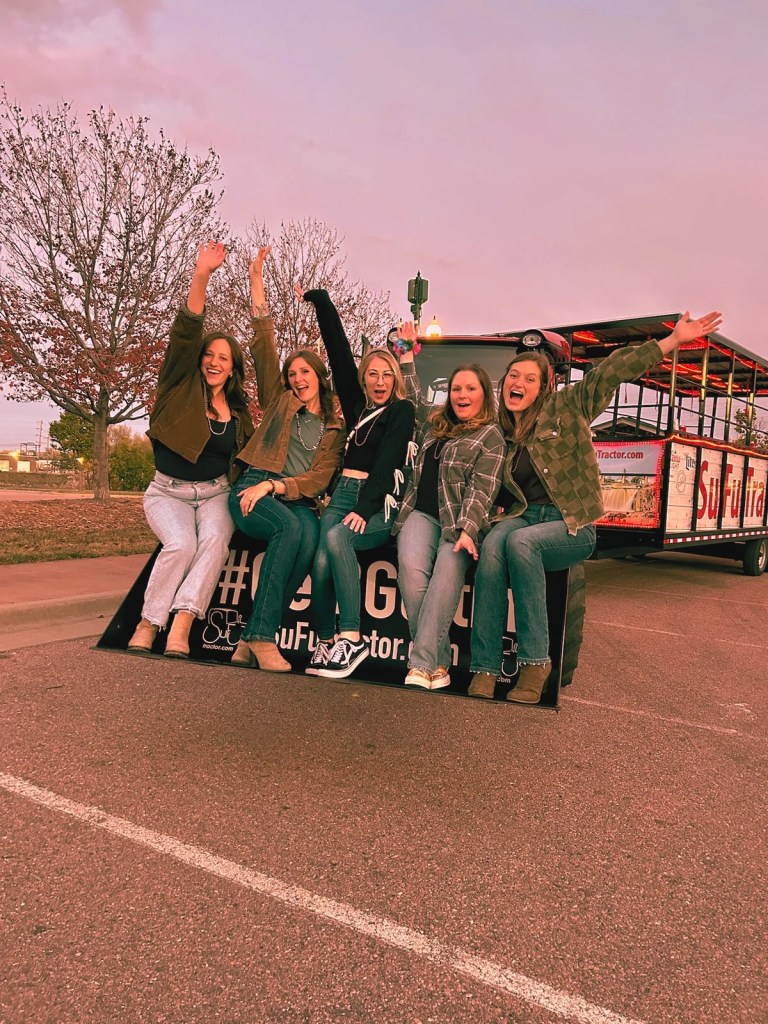 Group of women celebrating a girls night out on the SuFu Tractor party wagon in Sioux Falls SD